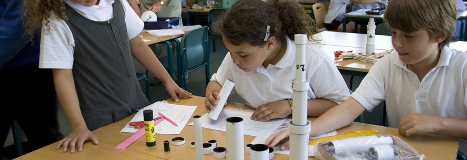 Children making telescopes from cardboard tubes