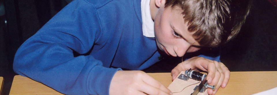 Young boy working on a morse code buzzer
