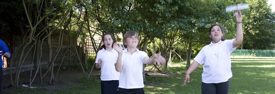Children testing aeroglide model planes outside