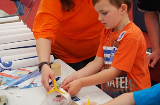 Young boy making a model helicopter