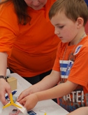 Young boy making a model aeroplane